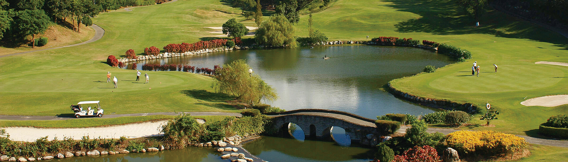 iconic stone arched "Red Bridge" spanning the water hazard