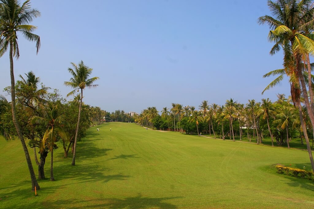 outdoor view of a grassy fairway at a golf course under a clear blue sky