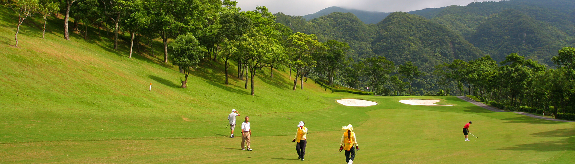scenic tropical golf course layout featuring rolling green fairways