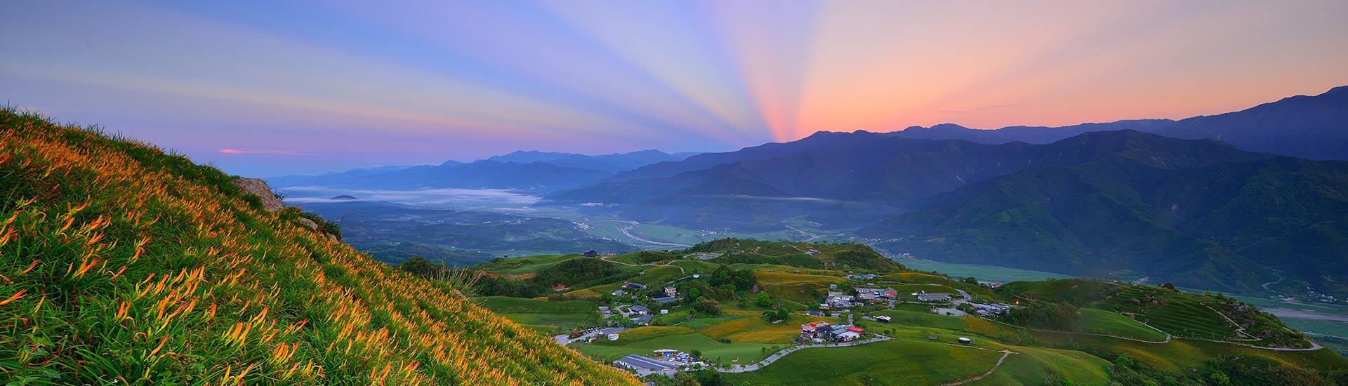 Lush green mountain peaks and valley landscape in Hualien County, Taiwan.