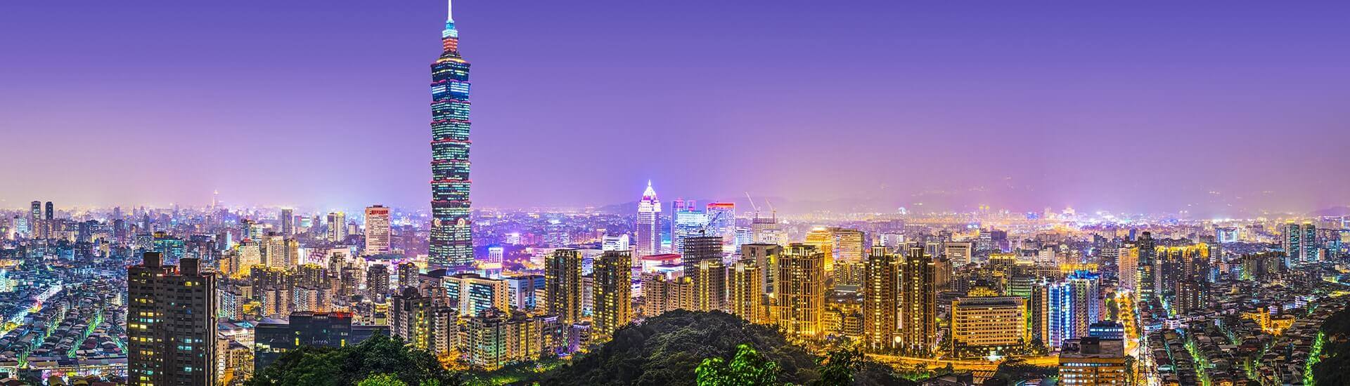 Vibrant night view of illuminated Taipei streets and bustling city architecture.